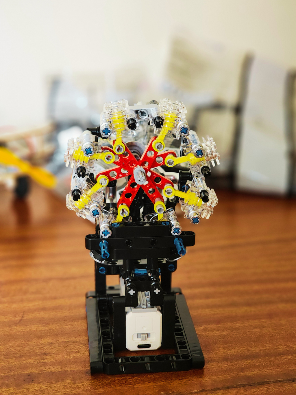 Front view of radial engine model kit showing cylinder layout, crank mechanism, and display base