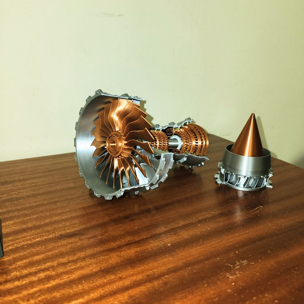 Trent 900 engine model parts laid out on wooden surface including fan section, shaft and nose cone