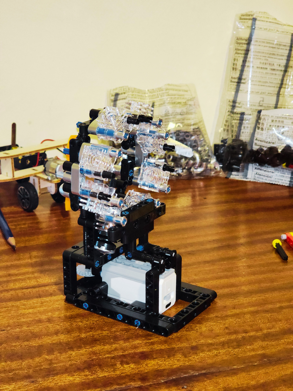 Side view of radial engine model kit showing transparent cylinders and engine structure during assembly