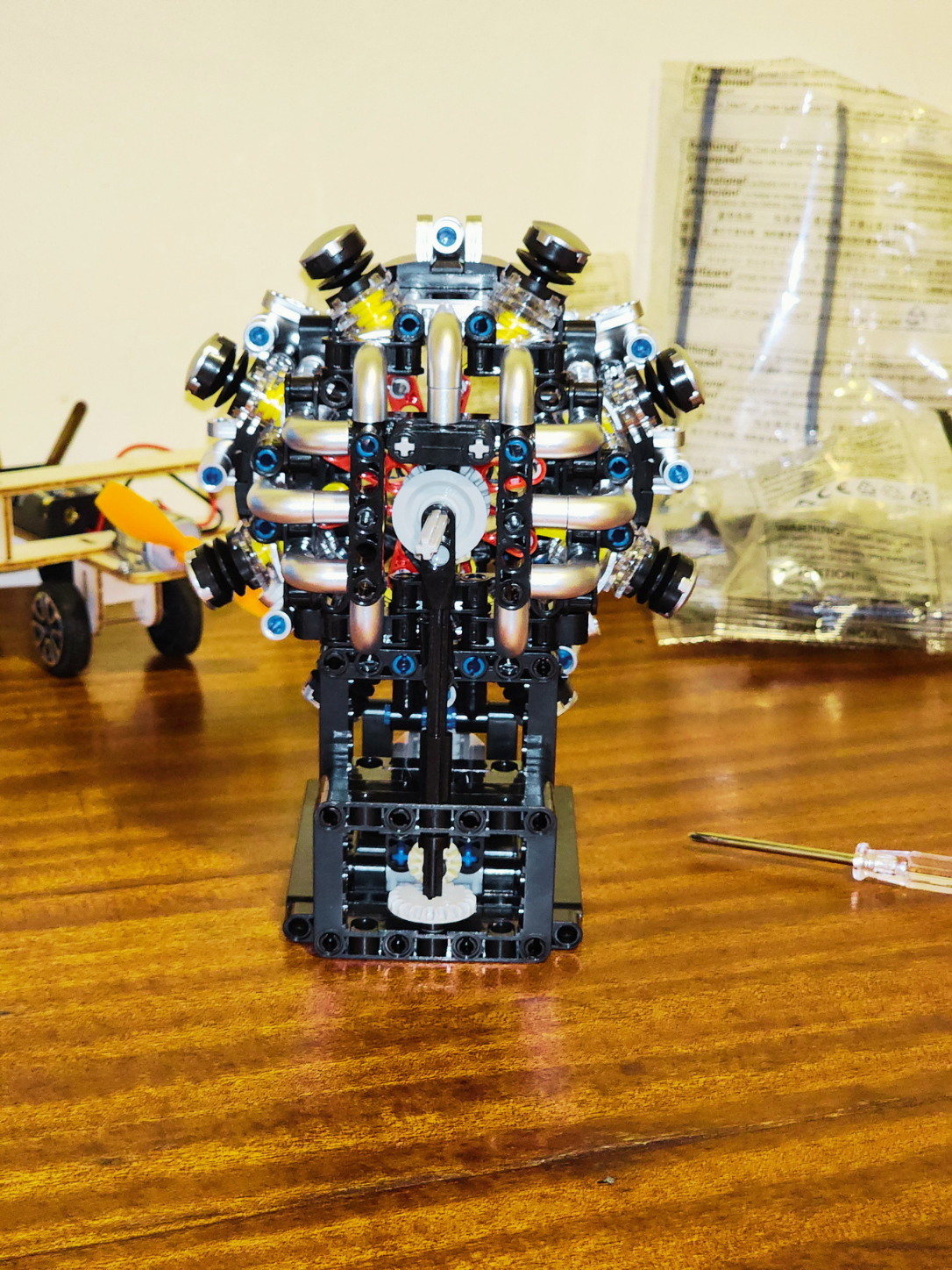 Rear view of completed radial engine model kit showing exhaust-style pipes, frame, and rotating mechanism